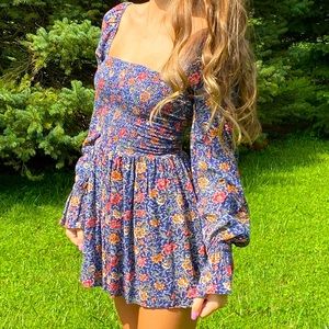 It’s an Urban Outfitters romper . Scrunchy middle with flowy bottom and arms .